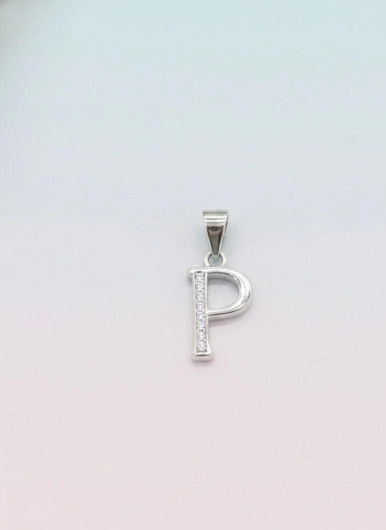 Silver pendant with the letter 'P' on a light pink background