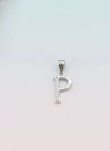 Silver pendant with the letter 'P' on a light pink background