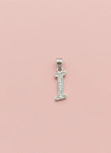 Silver letter 'I' pendant with small diamonds on a pink background