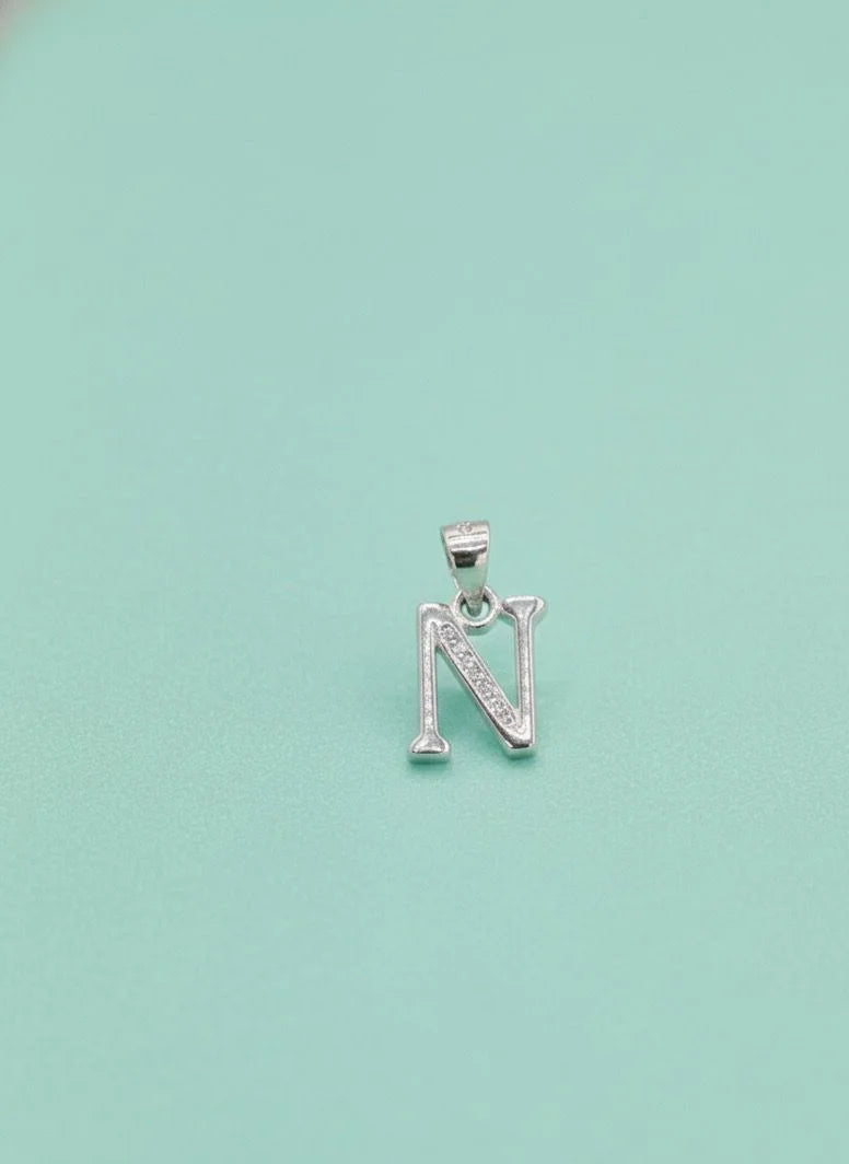 Silver 'N' pendant on a light blue background