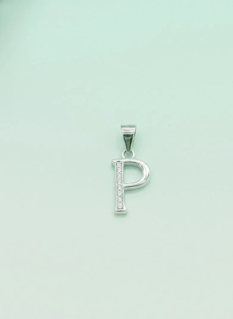 Silver 'P' pendant on a light green background