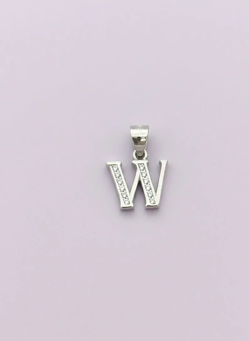 Silver letter 'W' pendant on a light purple background
