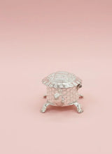 Silver decorative box on a pink background