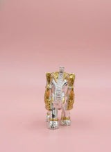 Decorative elephant figurine in silver and gold on a pink background