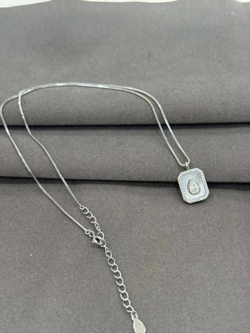 Pure 925 Silver necklace with a pendant on a gray surface