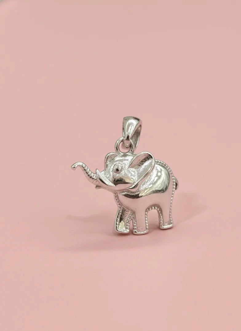 Silver elephant pendant on a pink background