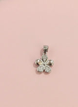 Silver four-leaf clover pendant on a pink background