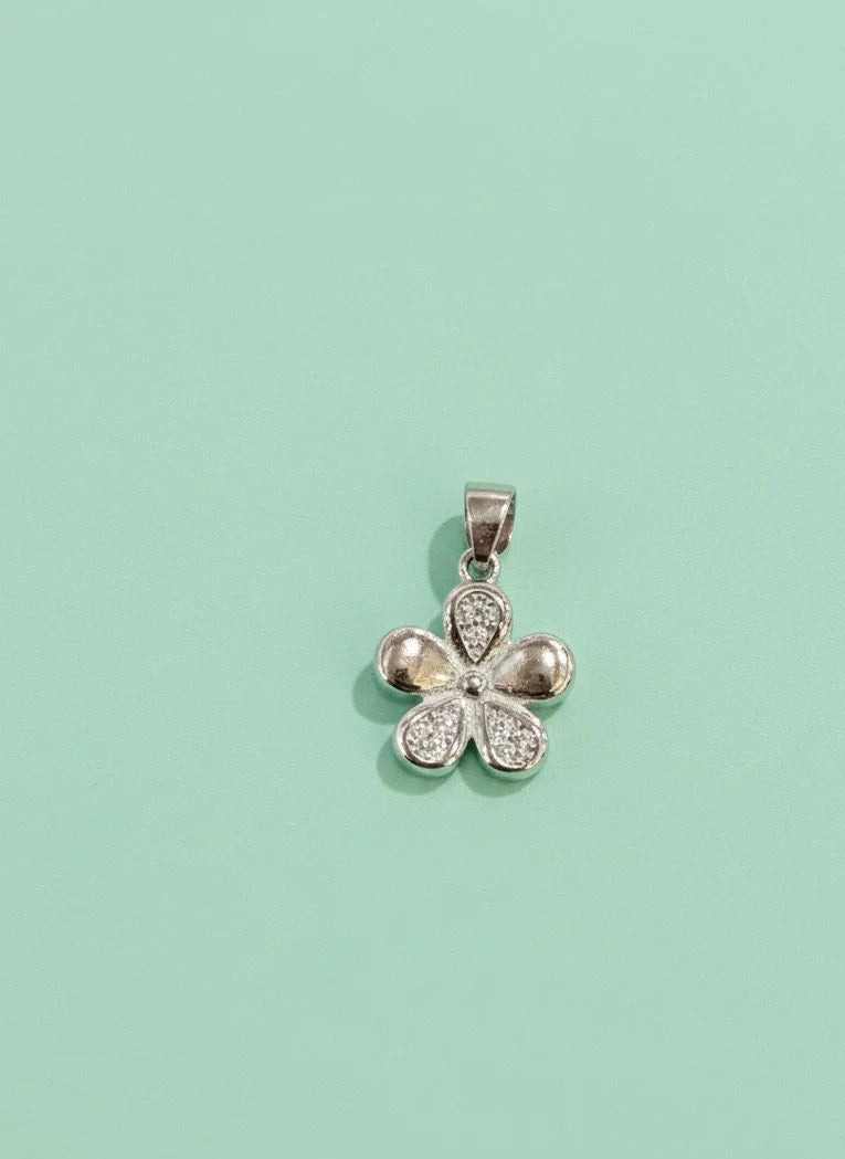 Silver flower-shaped pendant on a light green background