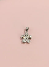 Silver four-leaf clover pendant on a pink background