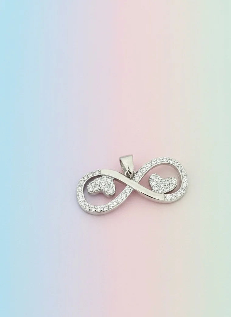 Silver infinity symbol pendant on a pastel gradient background