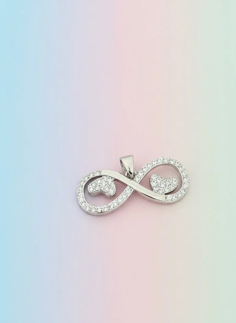 Silver infinity symbol pendant on a pastel gradient background