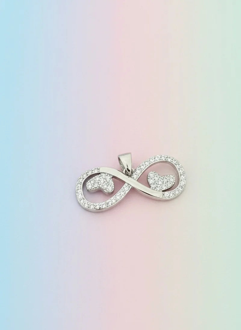 Silver infinity symbol pendant on a pastel gradient background