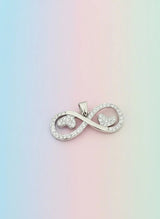 Silver infinity symbol pendant on a pastel gradient background