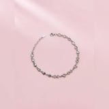Silver bracelet on a pink background