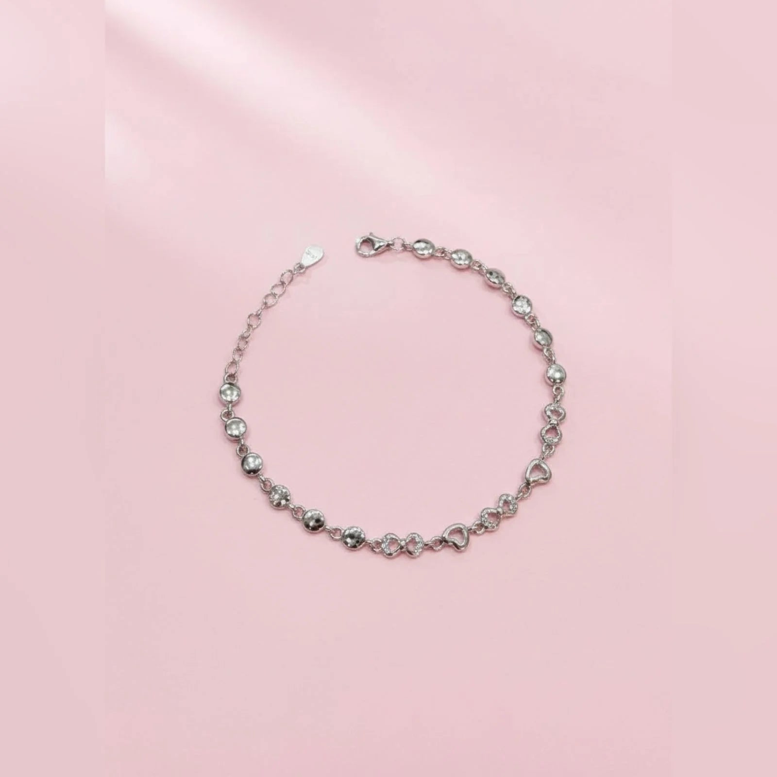 Silver bracelet on a pink background