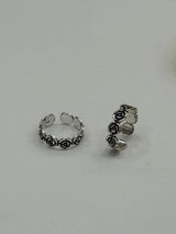 Silver toe rings 
with floral design on a light gray background