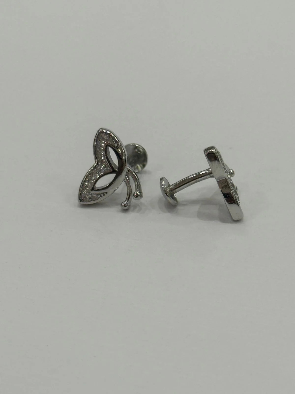 Pair of silver earrings on a light gray background