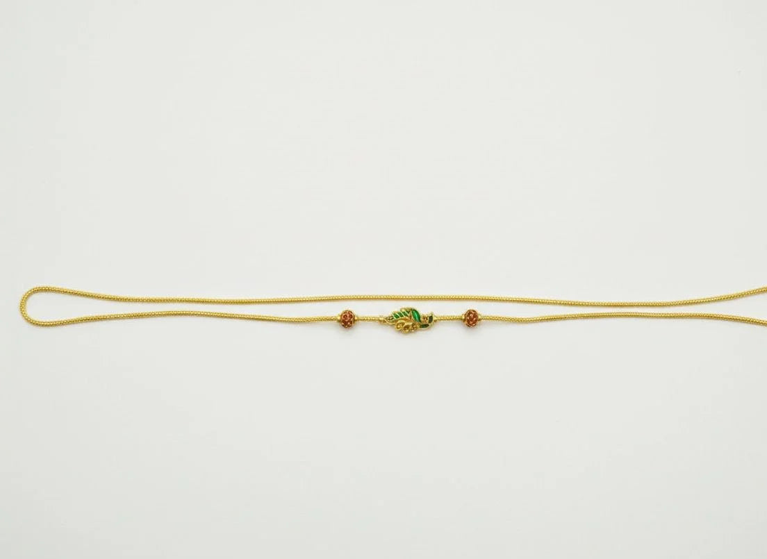 Gold chain with a decorative clasp on a white background