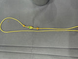 Gold chain with green gemstones on a gray background