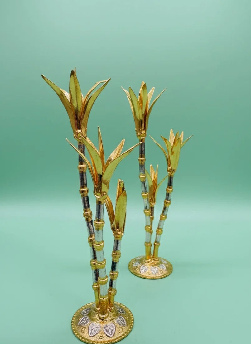 Decorative gold bamboo sticks with intricate designs on a green background
