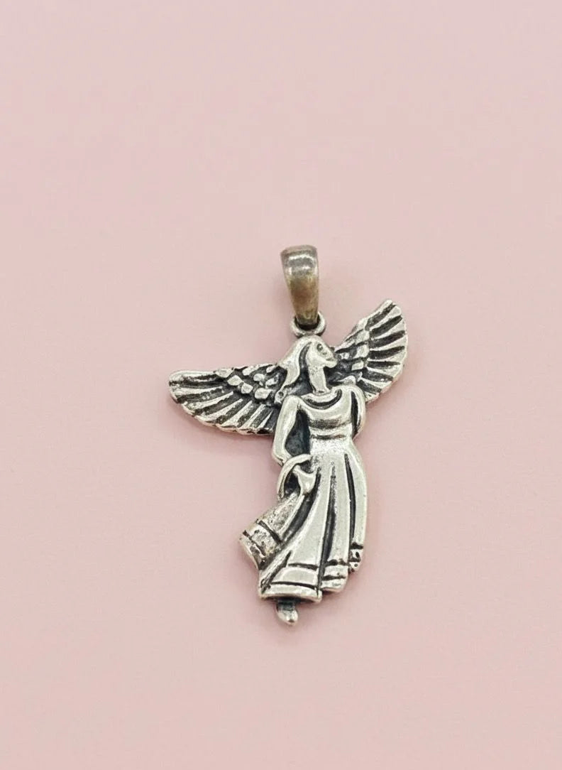 Silver angel pendant on a pink background
