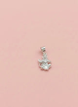 Silver pendant with a clear gemstone on a pink background