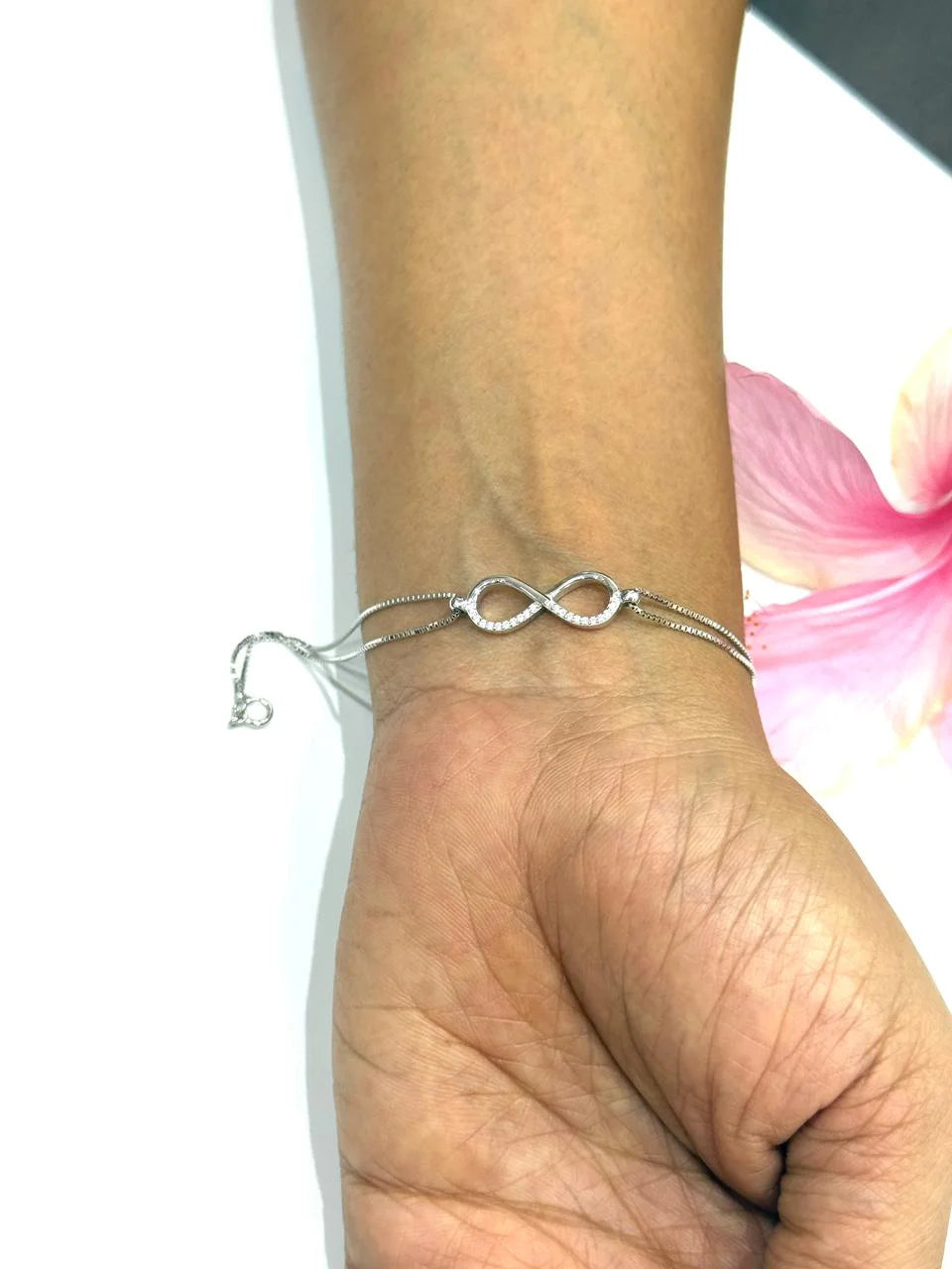 Silver bracelet on a wrist with a blurred background