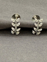 Silver leaf-shaped earrings on a gray background