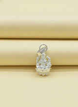 Silver pendant on a beige background
