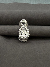 Silver pendant on a gray fabric background