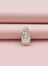 Silver pendant on a pink fabric background