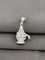 Silver pendant with a deity figure on a gray surface