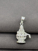 Silver pendant with a deity figure on a gray background