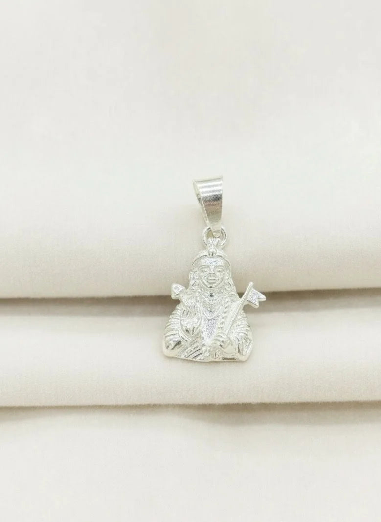 Silver pendant on a beige fabric background