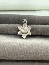 Silver star-shaped pendant on a textured surface