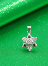 Silver star-shaped pendant on a green background