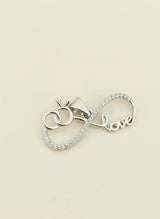 Silver Pendant with 'love' inscription on a beige background