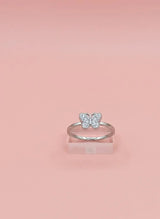 Silver butterfly ring on a pink background