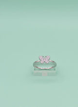 Silver butterfly ring on a light green background
