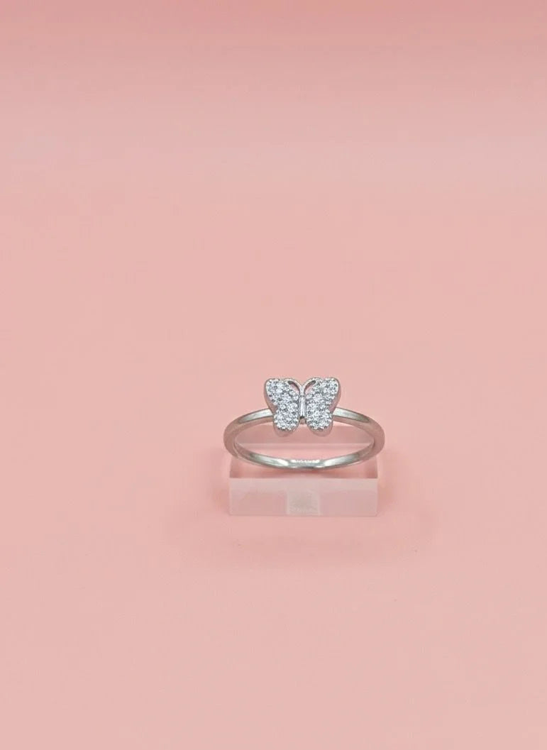 Silver butterfly ring on a pink background