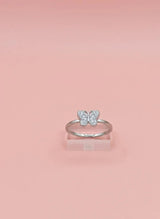 Silver butterfly ring on a pink background