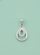 Silver teardrop pendant with embedded stones on a light green background