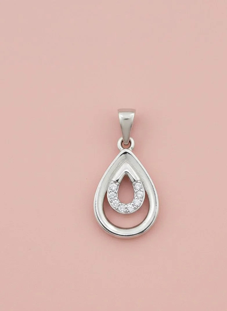 Silver teardrop pendant with embedded stones on a pink background