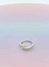 Silver ring on a gradient pink and purple background