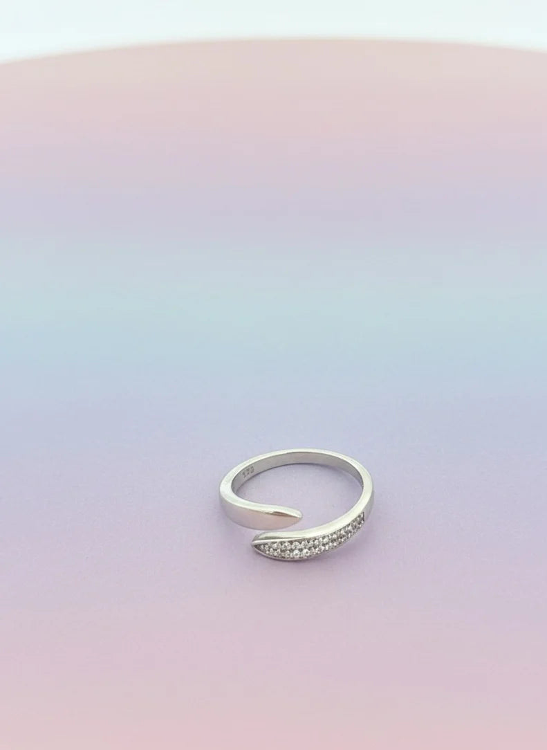 Silver ring on a gradient pink and purple background