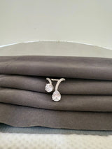 Pair of diamond finish rings on a gray fabric surface