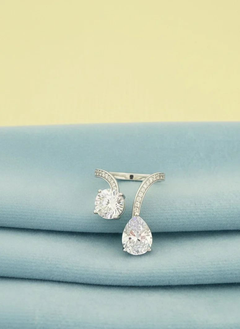 Pair of silver rings on a light blue fabric background