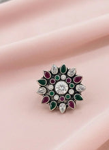 Decorative ring with gemstones on a pink fabric background