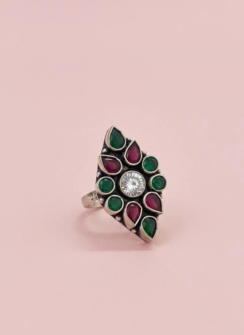 Decorative ring with gemstones on a pink background