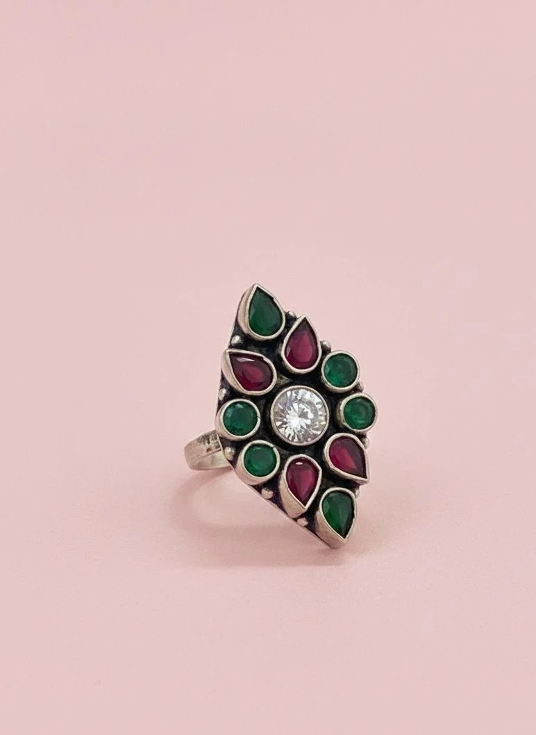 Decorative ring with gemstones on a pink background